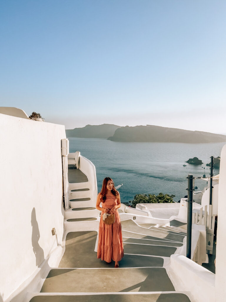 Staircase in Oia, Santorini, showcasing whitewashed buildings and overlooking the Aegean Sea.