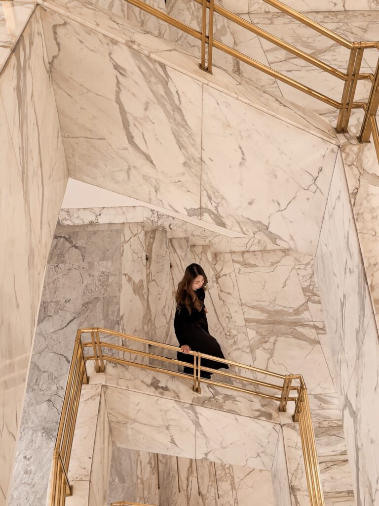 marble staircase at Almanac X Alcron Prague Hotel featuring local artwork in a hotel review of Almanac X Alcron, one of best hotels to stay in Prague