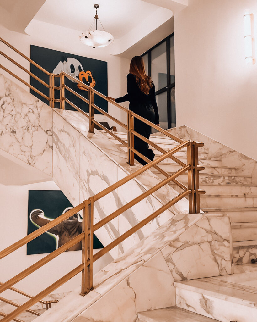 marble staircase of Almanac X Alcron Prague Hotel featuring local artwork in a hotel review of Almanac X Alcron, one of best hotels to stay in Prague