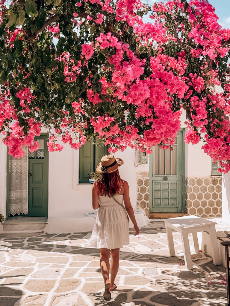 A woman walking under Bougainvillea in Prodromos, a cute village in Paros, Greece in Paros travel guide