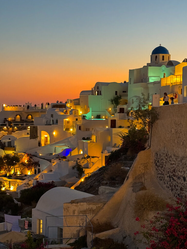 Breathtaking sunset over Oia, Santorini, illuminating the sky with hues of orange and pink