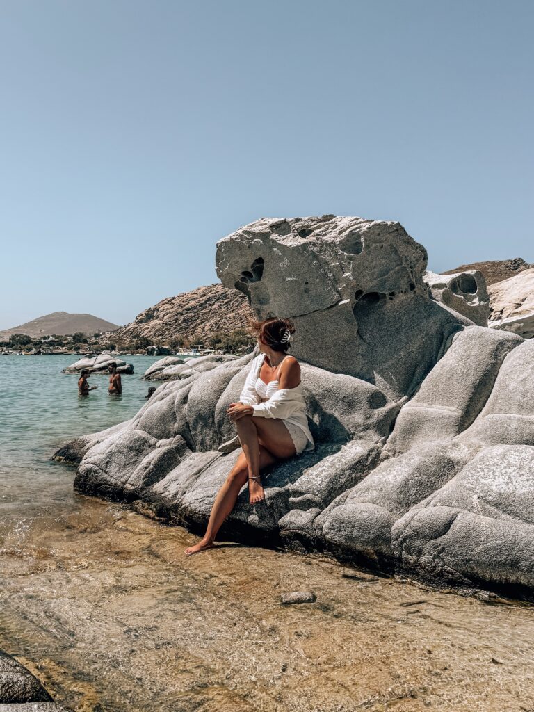 Sitting on the granite rocks of Kolymbithres Beach in Paros, best beach of Paros