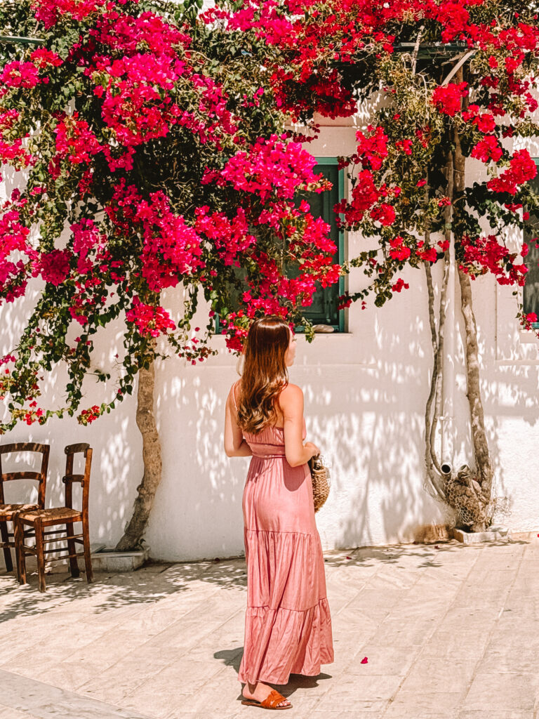A woman standing under Bougainvillea at Lefkes, Paros, Greece in Paros travel guide