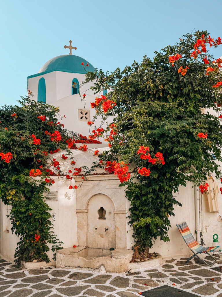 Blue domed church in Parikia, Paros, Greece with bougainvillea in the Paros Travel Guide
