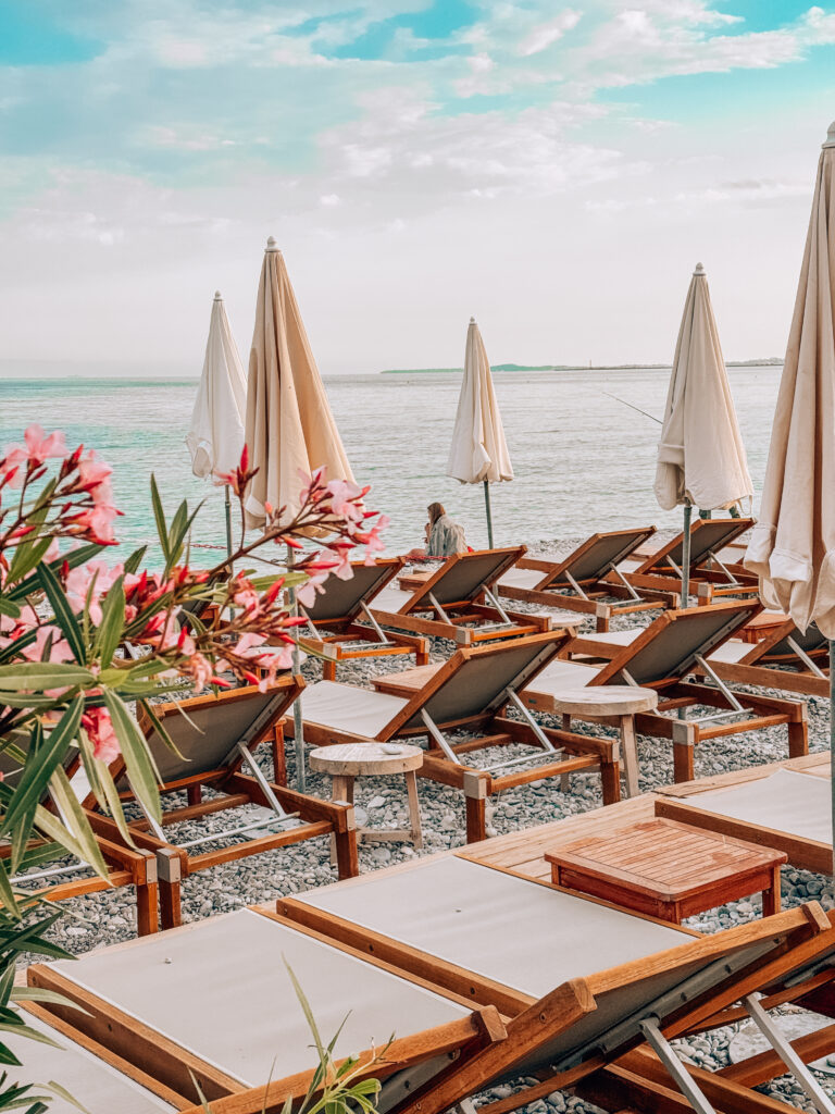 beach chairs and sunbeds at a beach club in Nice, France