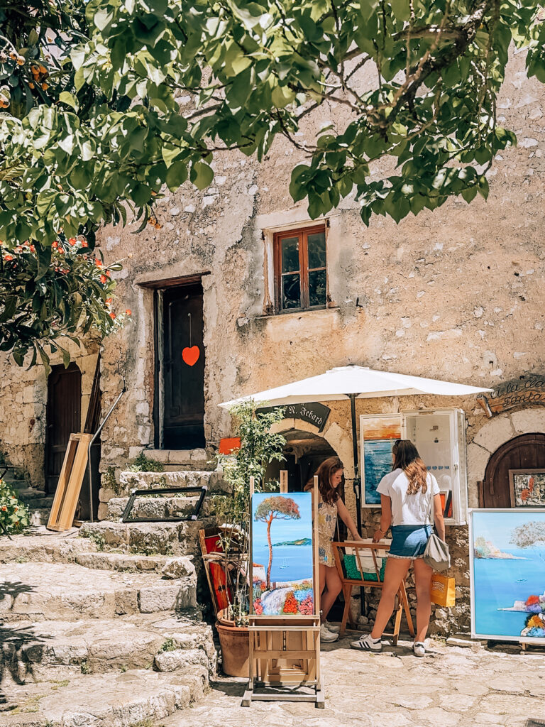 Women exploring art work at a gallery in Eze Village France
