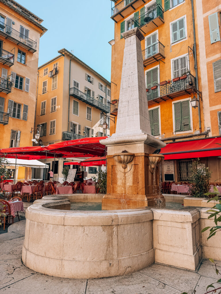 Colorful buildings of Vieux Nice, Old town of Nice with a fountain at Pl. Rossetti