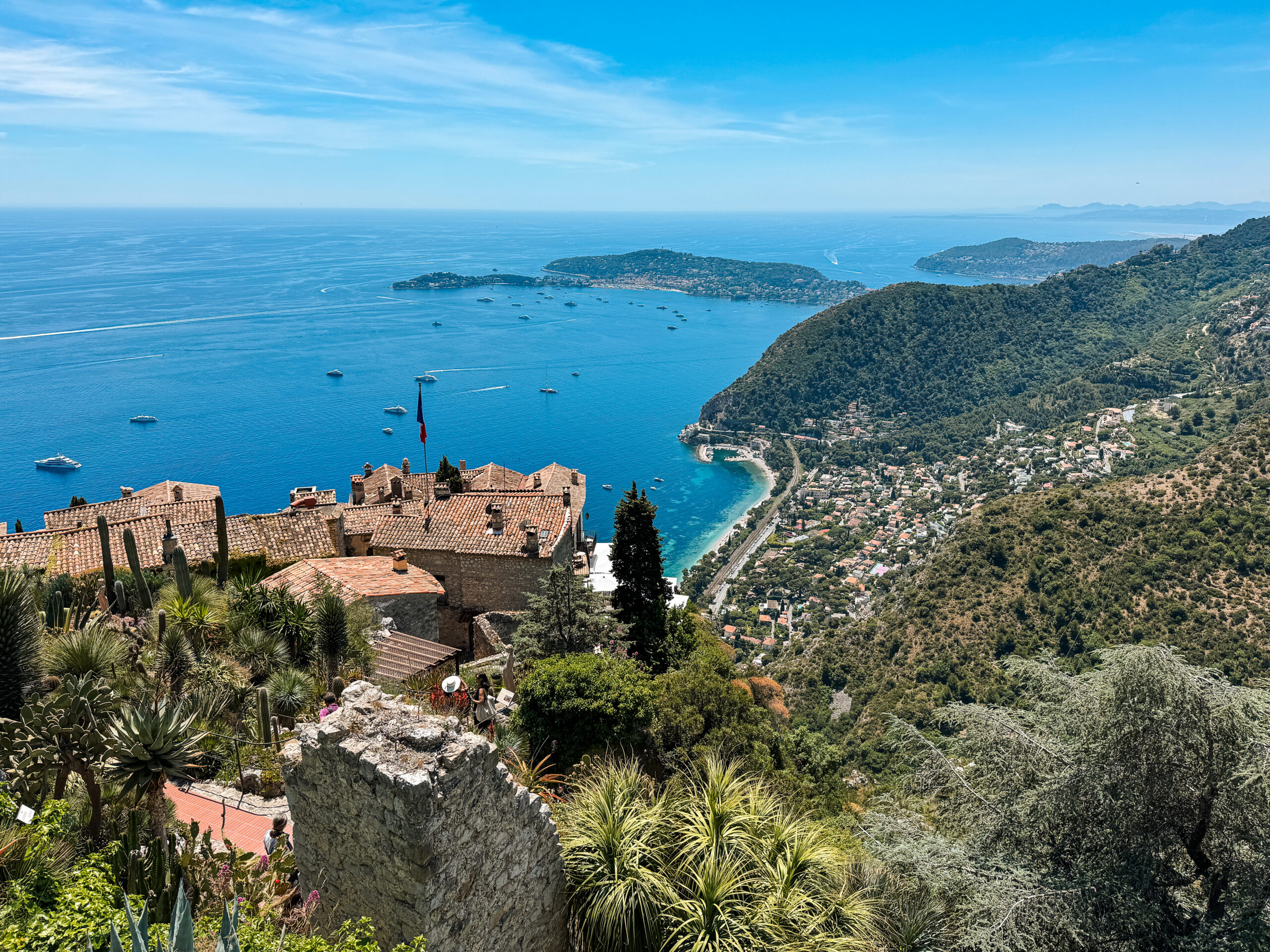 Views of blue Mediterranean sea and charming stone houses as seen from high up on the hill from Jardin Exotique d'Eze. 