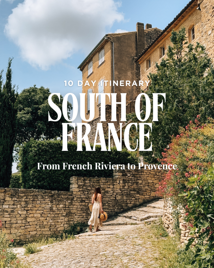 A woman in a flowy dress walks up a cobblestone street in a charming Provençal village, with warm stone houses and lush greenery surrounding her. Text overlay reads: “10 Day Itinerary – South of France – From French Riviera to Provence.”