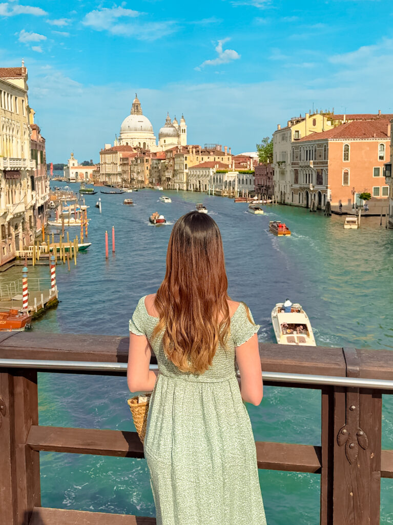 a woman admiring views of venice from accademia bridge

