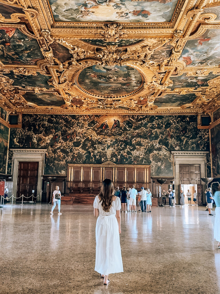 A woman walking through Doge's Palace 