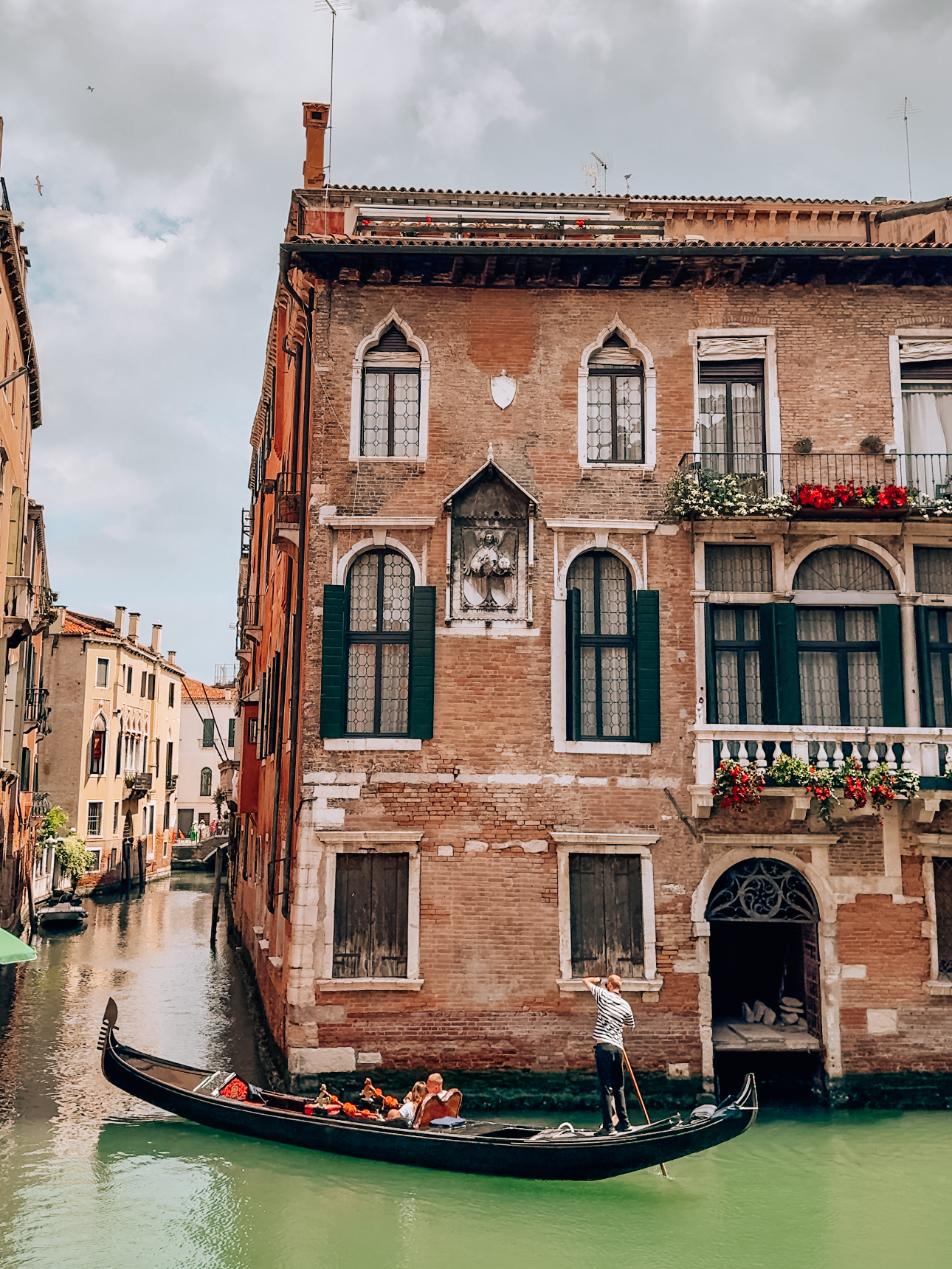 charming house in venice with a gondola gliding by in the canals
