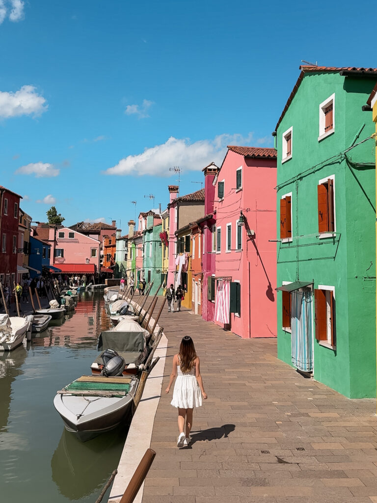a woman walking on Burano island on her day trip from venice