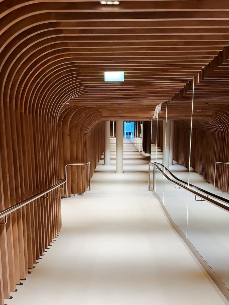 Curved wooden spa hallway at Hotel Krallerhof with soft lighting and modern alpine design