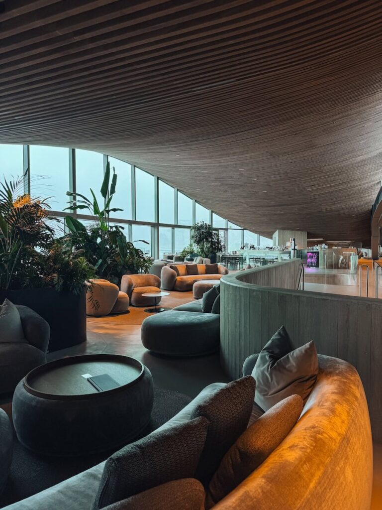 Modern cafe lounge at Hotel Krallerhof with curved wooden ceiling plush seating and floor to ceiling windows