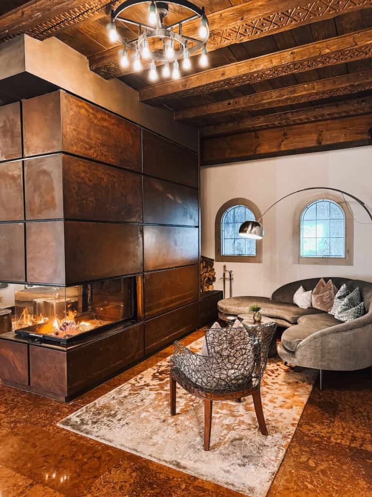 Cozy lounge at Hotel Krallerhof with a modern fireplace warm lighting and rustic wood details