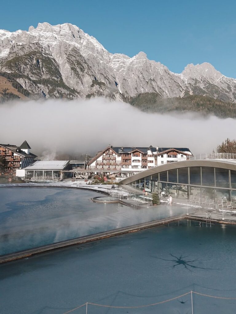 Outdoor infinity pool at Hotel Krallerhof with dramatic mountain backdrop in Leogang Austria