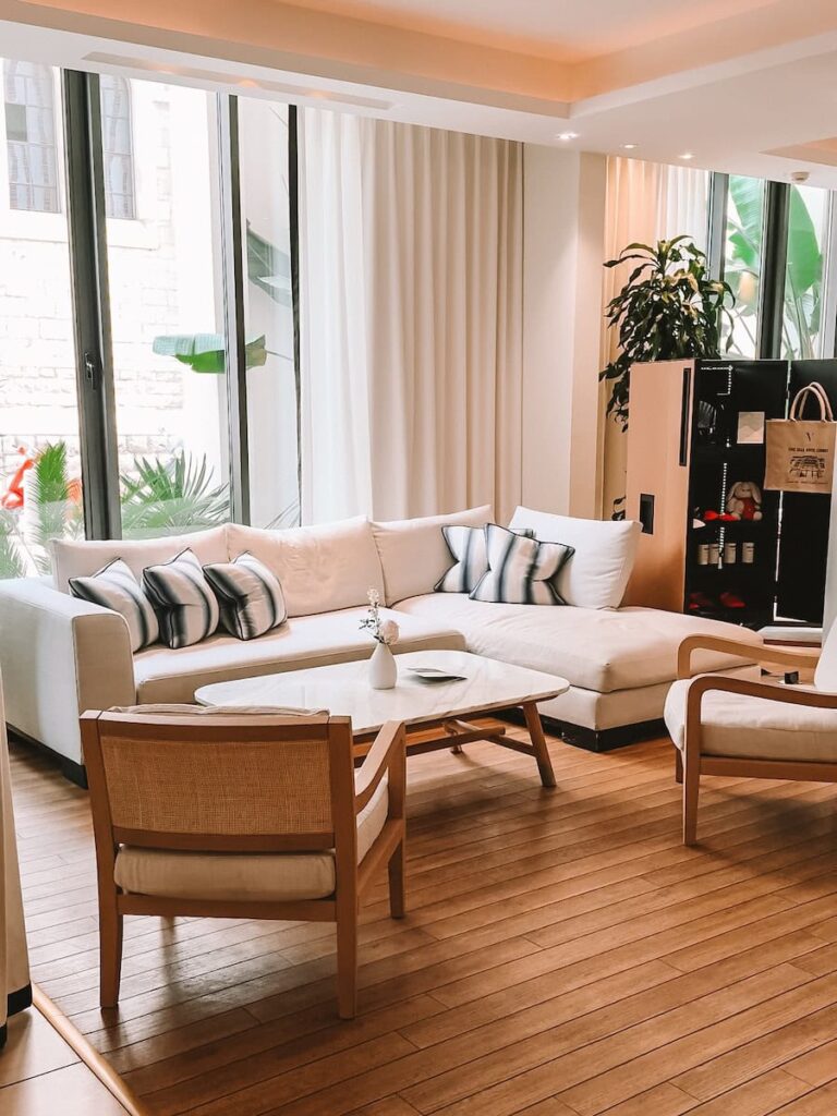 Bright lobby lounge at Five Seas Hotel Cannes featuring neutral seating indoor plants and natural light