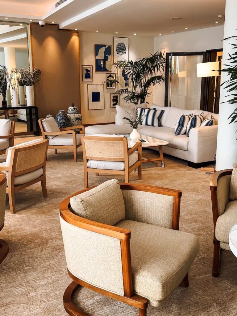 Elegant lobby lounge at Five Seas Hotel Cannes with curated artwork plush seating and warm lighting