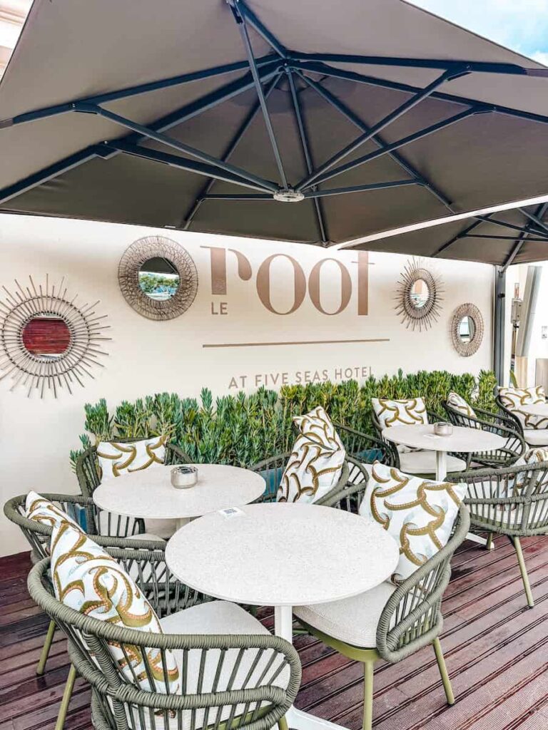 Le Roof rooftop terrace at Five Seas Hotel Cannes with styled outdoor tables chairs and branded wall signage