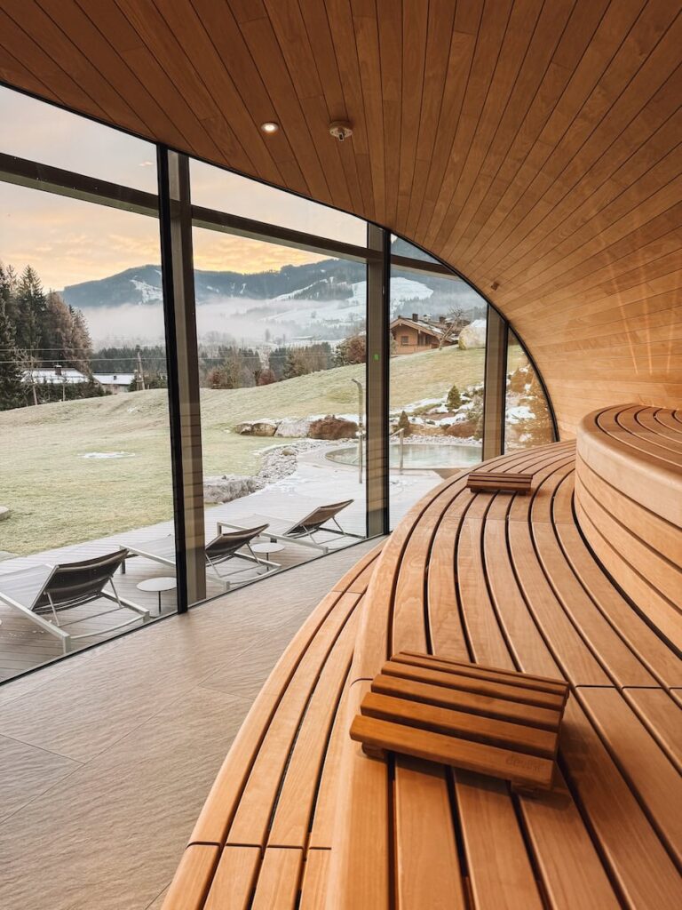 Panoramic sauna at Hotel Krallerhof with floor to ceiling windows overlooking alpine hills