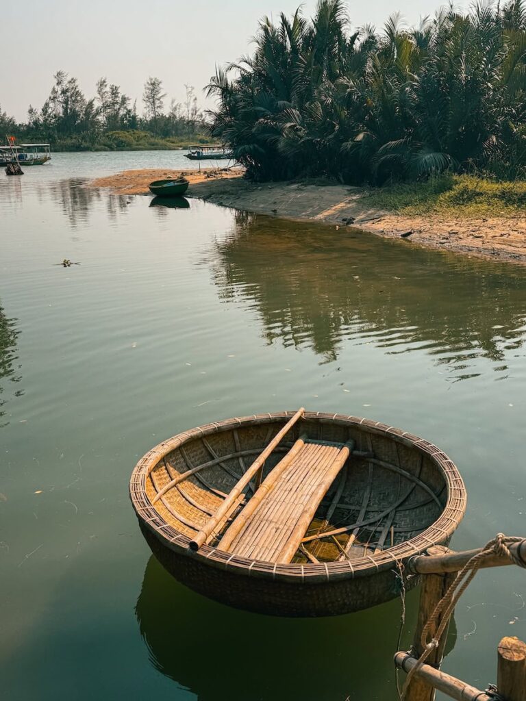Traditional round basket boat floating on the Thu Bon River near Hoi An, Vietnam