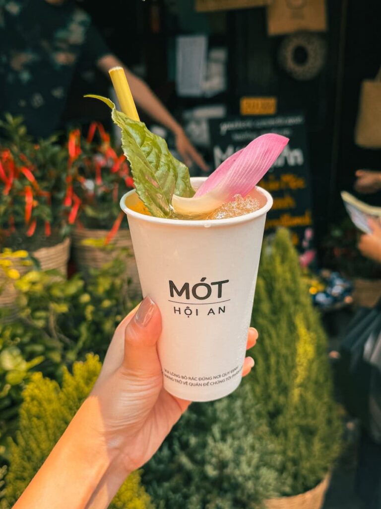 Traditional herbal drink from Mot Hoi An served with lemongrass and lotus leaf garnish