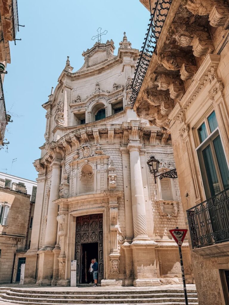 The ornate Baroque façade of the Basilica di Santa Croce in Lecce, featuring intricate stone carvings, decorative columns, and one of the finest examples of Lecce's signature architecture.