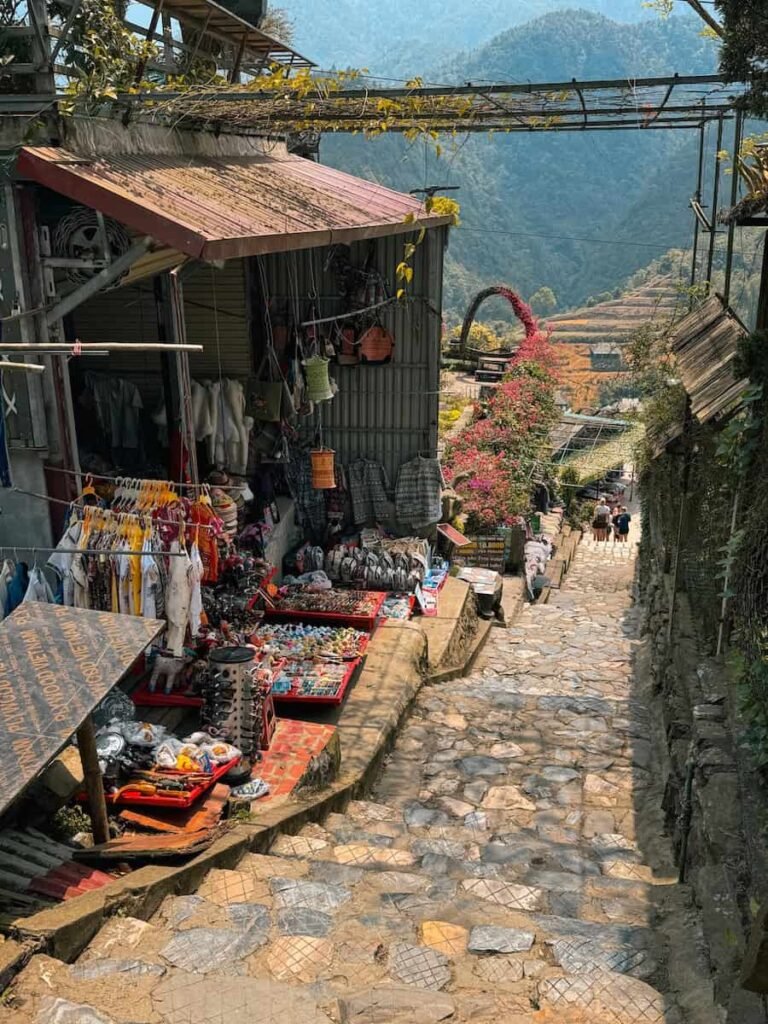 Waterfall and traditional buildings at Cat Cat Village near Sapa
