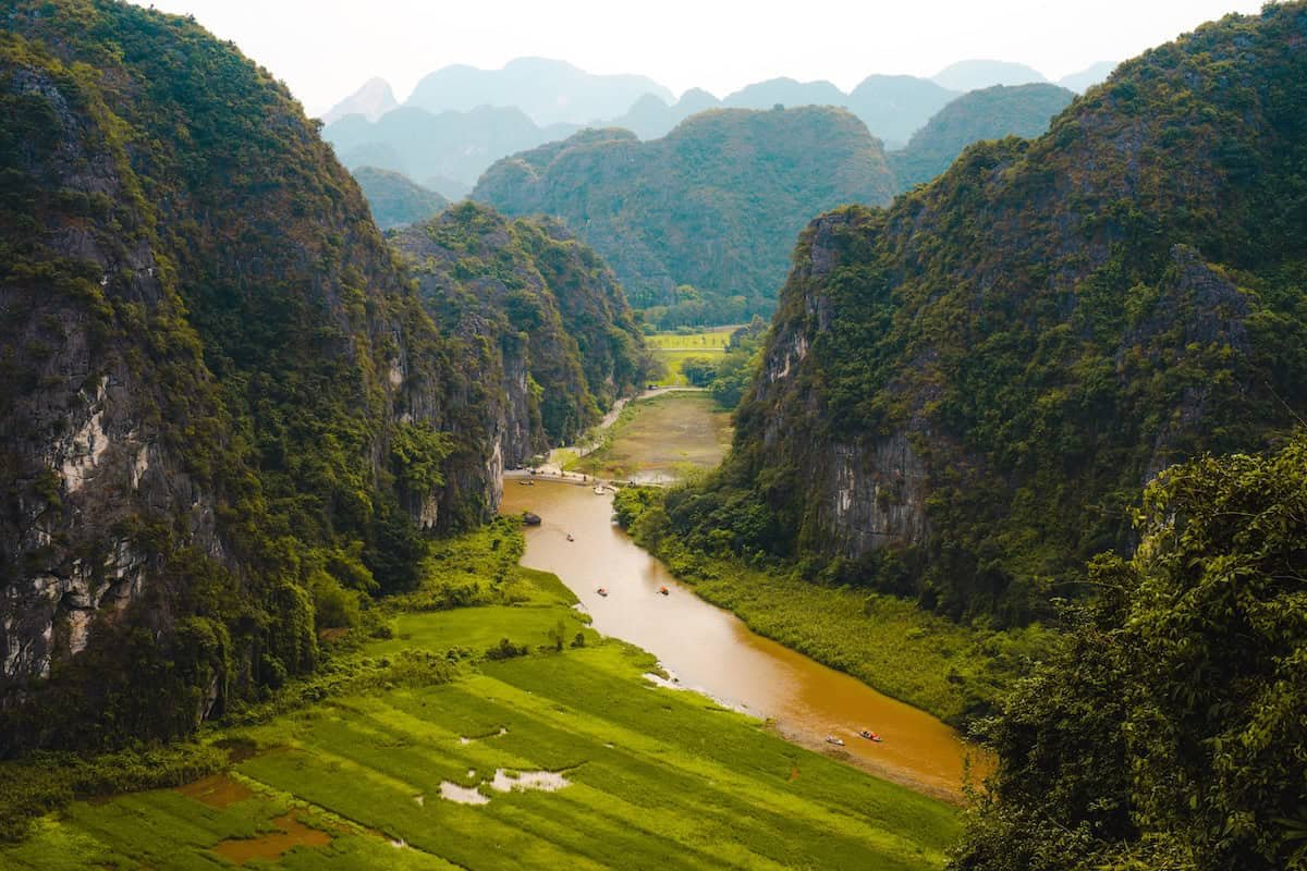 View from Hang Mua over the Ngo Dong River winding between limestone karsts and rice fields in Ninh Binh, Vietnam